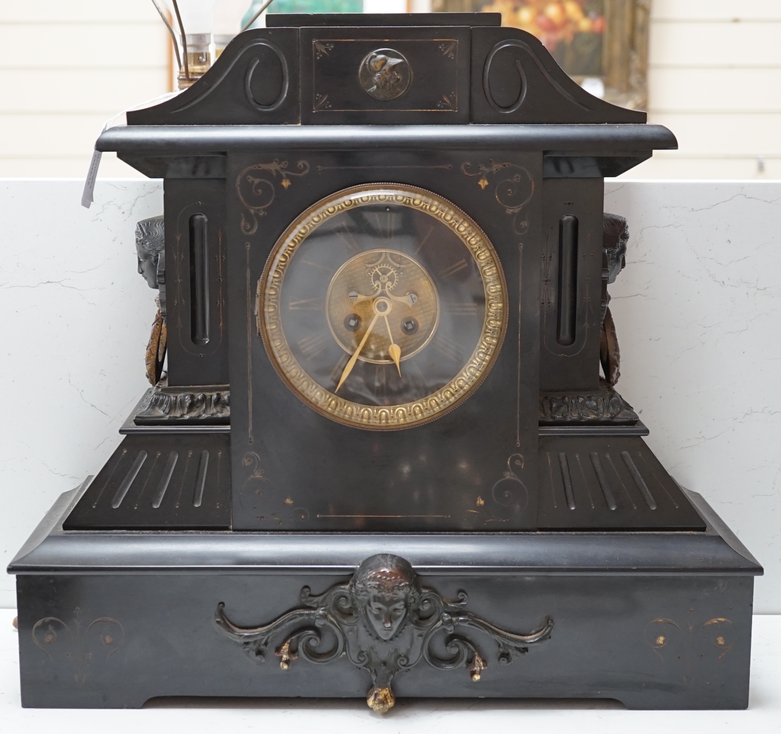 A large black slate mantel clock, with visible Brocot escapement, 45cm high